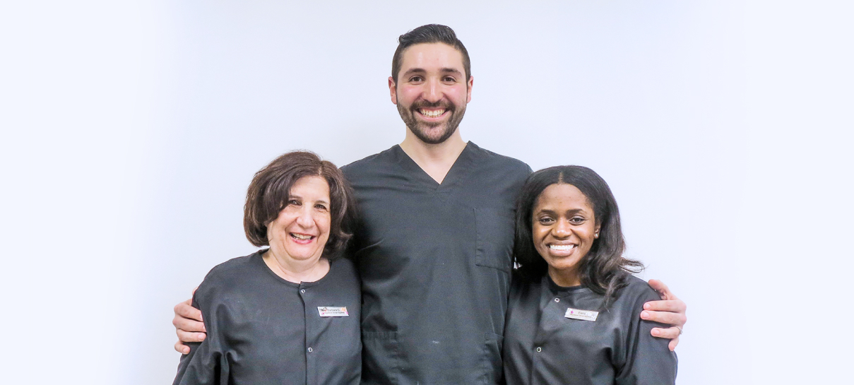 a man and two women standing next to each other