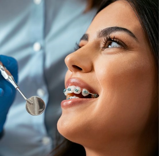 A girl with braces being worked on